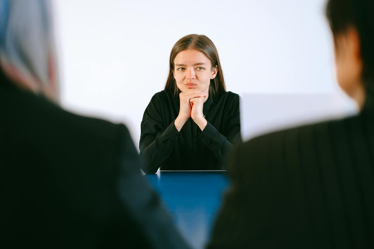 a woman being interviewed by two people
